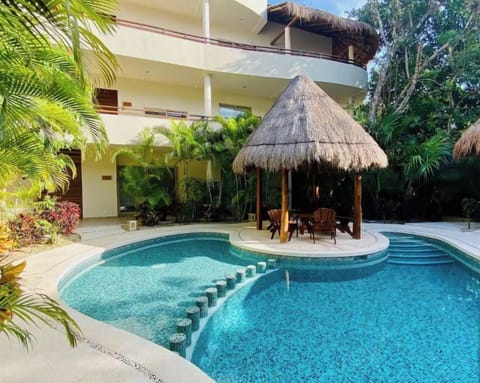 Our lush, tropical, newly-renovated pool is just steps from our patio 