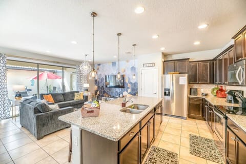 2.	Step into our beautiful kitchen area. Filled with everything you need - from the stainless steel fridge to the large island with lots of counter space and all kitchen essentials.