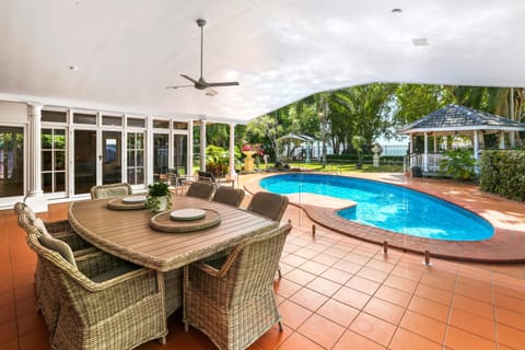 Huge outdoor entertaining area with BBQ overlooking the pool and beach