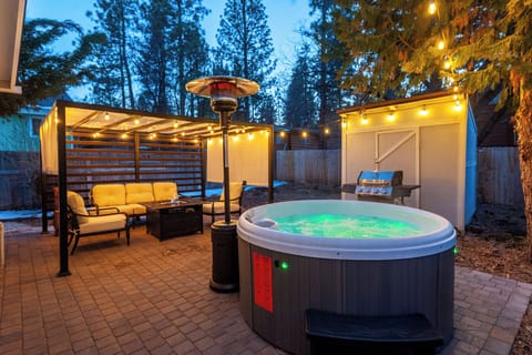 Unwind in your private hot tub under glowing string lights and stars