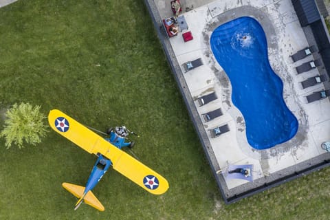 Enjoy private pool and hot tub while watching aircraft lift/land on airstrip.