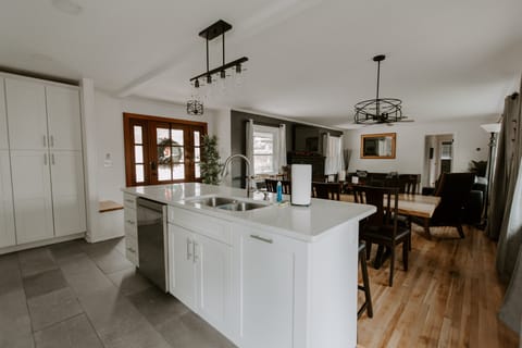 Kitchen island with sink and dishwasher.