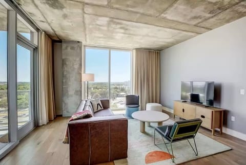 Open living room and dining area with floor to ceiling windows