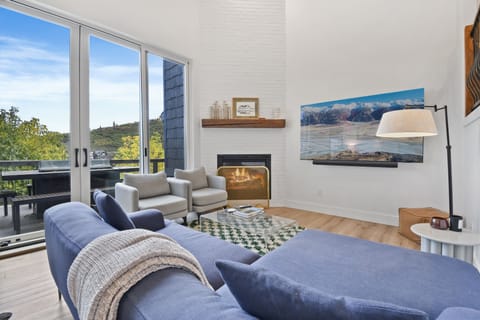 Deluxe Townhome | Living area | 60-inch flat-screen TV with cable channels, fireplace