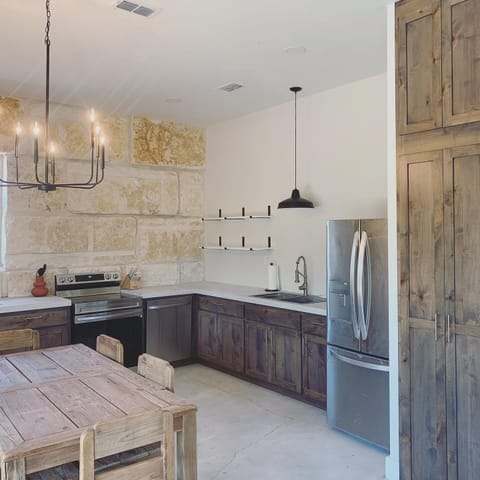 The microwave is located inside the pantry.