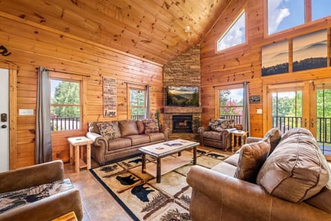 Large living room with lots of comfortable furniture, soaring ceilings, and lots of natural light.