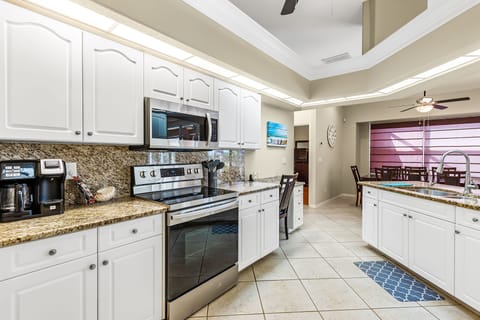 Range area in Kitchen with Desk area/work station on the far right of cabinets
