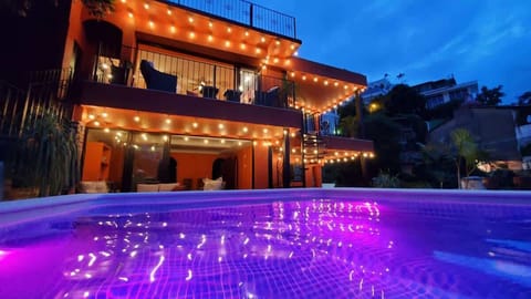 Evening view of the Villa from the pool. From Top Floor Left going clockwise: Ivan's Bella Vista, Miguel's Mirador, Jonathan's Lugar, Curiel's Retreat.  All four apartments combine to create the Entire Villa. 