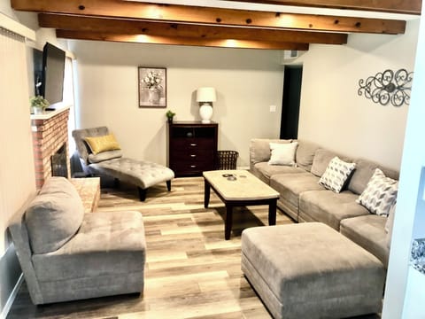 Den with sectional couch, lounge chair, 50” smart TV and gas fireplace.