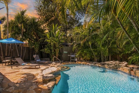 Golden hour glow over your private tropical oasis—unwind poolside beneath the palms and soak in the serene backyard setting.