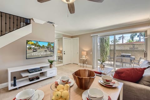 Sophisticated living room design with a small dining/work desk area, a sofa that opens to a full-size bed, 55” Smart TV, beautiful decor, and much more.