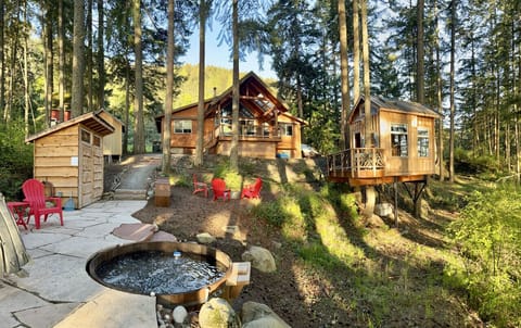 The setting of this cabin is superb, on a hillside with views on both sides. Paths wind through the backyard, to the firepit, hammock, shower house and the cedar hot tub!