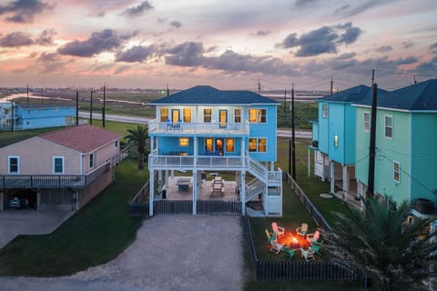 Golden-hour welcome — firepit already lit, deck seating for the crew, Gulf just 3 minutes away. Your beach week starts here
