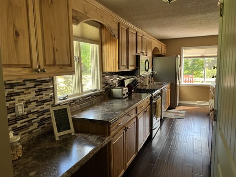 Kitchen with keurig/drip coffee maker, toaster, blender, mixer, pans/dishes 