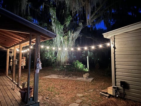 Property has a front porch with two chairs and a table.