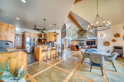 Open-concept living area with gourmet kitchen, dining, and cozy fireplace.