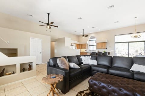 Living room with the kitchen in the background.