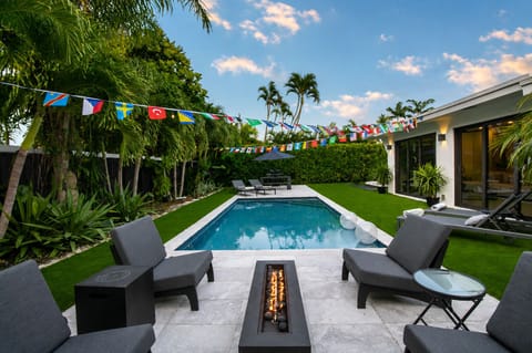 Relax in the private backyard, with amazing pool views day & night and amenities that include soft artificial turf, patio, pool lounge chairs, umbrellas, outdoor dining table and a BBQ grill all surrounded by palm trees and tropical landscaping.