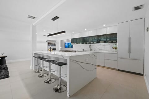 Prepare a family meal in the fully-equipped kitchen offering updated appliances and cookware, luxury quartz countertops and cabinetry and dine-in bar seating. The kitchen is situated in the open layout, which makes it perfect for gathering and entertaining.