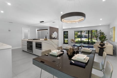 Prepare a family meal in the fully-equipped kitchen offering updated appliances and cookware, luxury quartz countertops and cabinetry and dine-in bar seating. The kitchen and dining area are situated in the open layout, which makes it perfect for gat