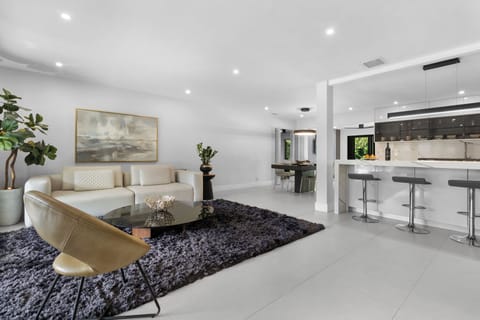 Spread out in the spacious layout of this Wilton Manors pool home, which offers 3 bedrooms & 2 full bathrooms, natural light-filled living areas with comfy furniture and pool views, a modern dining table for six, fully-equipped kitchen with updated a