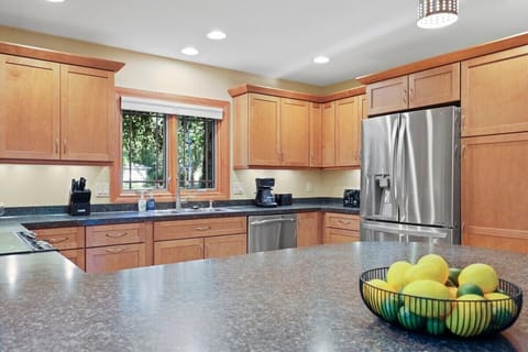 Fully stocked kitchen with barstool seating.