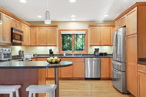 Fully stocked kitchen with barstool seating.