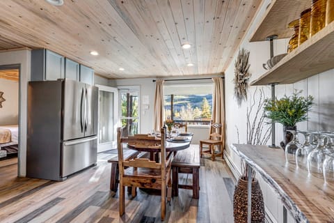 Alfresco Dining and Relaxation: Step out onto the back deck from the dining room to enjoy the BBQ, seating area, gas fire pit, and a dog run area, all set against the backdrop of serene nature. 