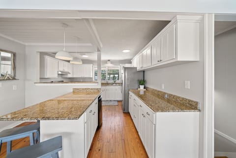 A fully stocked kitchen with breakfast bar invites casual meals or group cooking