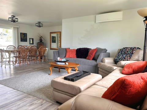 Open concept living and dining room with large windows for lovely natural lighting. Comfortable seating in the livng room.