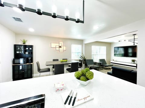 Open concept large kitchen island with quartz countertop and many seating.