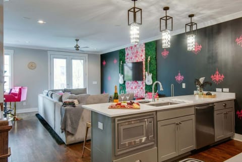 Open-concept living and kitchen flow together so no one gets stuck cooking while the party happens elsewhere. The island, the sectional, and the pendant lights all say come hang here