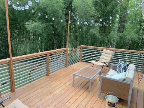 Relax on the private back deck with family and friends secluded by bamboo trees.