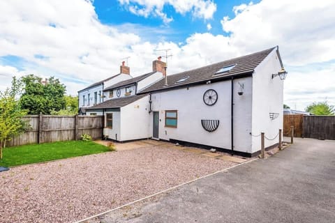 To the front of the property, there is additional green space and more parking.