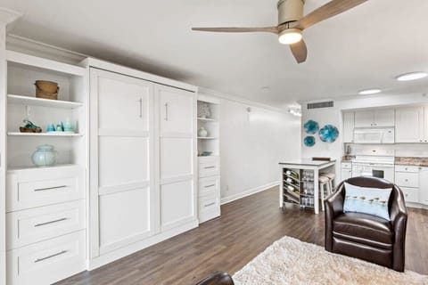 Living space includes four top dining island, fully equipped kitchen, and space for the entire family to relax while on vacation