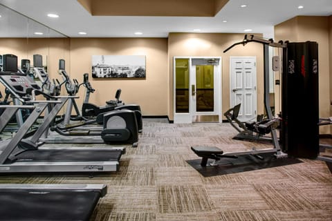 Well-equipped fitness center with cardio machines and strength training equipment.
