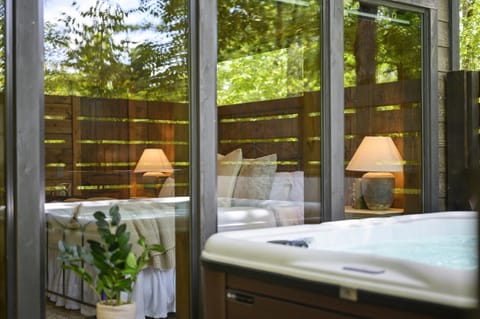 The hot tub sits in a private, carefully chosen spot — ideal for unwinding and soaking under the trees.