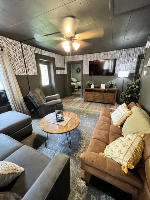 View from back wall of living room looking into large front bedroom.