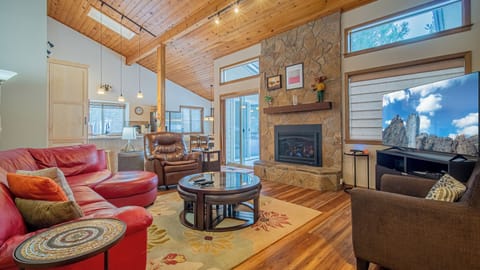 Cozy up in your mountain retreat with exposed beams, stone fireplace, and leather seating—perfect for relaxing after outdoor adventures.
