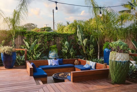 Romantic sunken firepit surrounded by lush tropical landscaping.