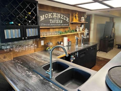 Downstairs bar area with full sink and extra refrigeration. 