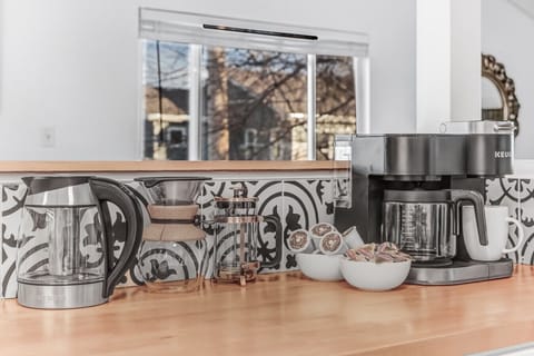 The deluxe coffee bar includes a Keuirg, drip coffee, French press, pour over coffee, and a tea kettle