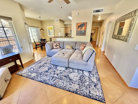 Living room with comfy sectional and huge smart TV