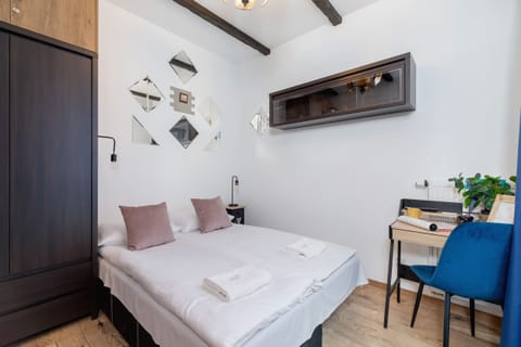 A bright bedroom with a comfortable double bed, soft pillows, and modern wall decor for a cozy ambiance.
