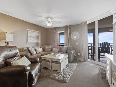 Sink into plush leather seating while ocean breezes flow through your private balcony doors, creating the perfect coastal retreat.