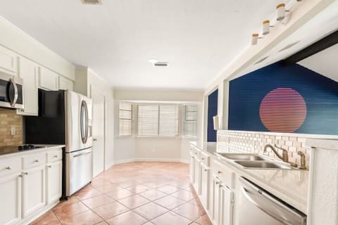 The large kitchen opens to the dining and living areas.