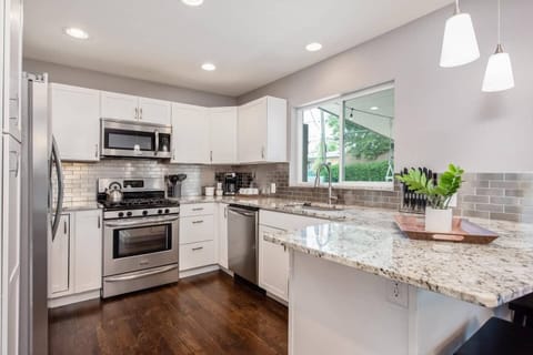 The kitchen offers ample counter space, updated stainless appliances and all kitchen necessities required for your next meal