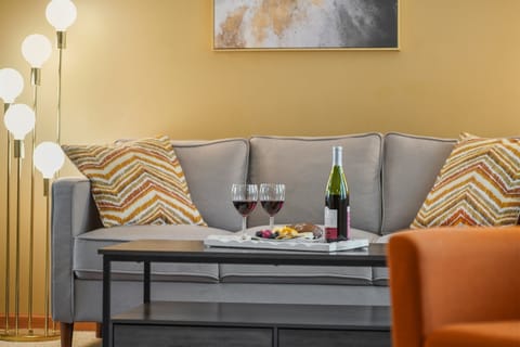 Living Room: Enjoy wine and snacks in this stylish retreat with warm lighting and vibrant decor!