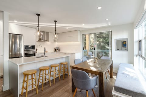 Kitchen/Dining Room: Spacious and open for family meals, bar seating, modern and bright, large dining table seating 7-8