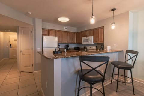 Cook your favorite meals in this fully equipped kitchen featuring granite counters, stainless appliances, and a breakfast bar for casual dining.